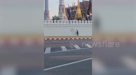Brave protester arrested while spraying anti-monarchy slogan on temple wall in Thailand
