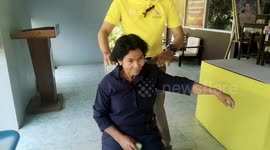Police officer gives station visitors a massage to 'ease their tension'