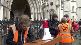 Just Stop Oil activists support Lawyers Are Responsible group outside the Royal Courts of Justice in London