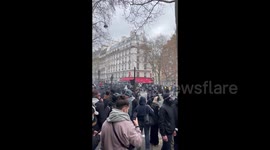 Police clash with protesters at the pension reform protest in Paris, France