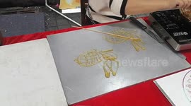 An Artist Makes A Sugar Painting in Haikou, China