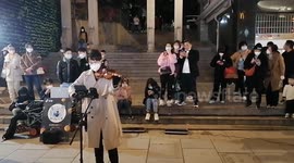 A Violinist Attracts Crowds on A Pedestrian Street in Xiamen, China