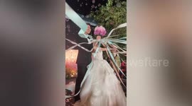Bride falls down steps while throwing bouquet in amusing wedding fail