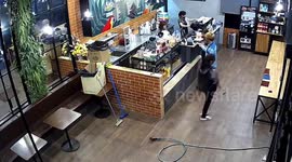 Panicked coffee shop worker flees hose that started spraying water