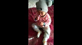 The baby is playing with her mom lipstick and she don't have any idea