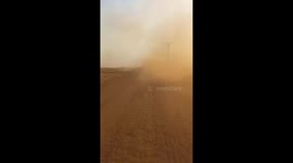 The truck driver moves the truck at high speed while the dust road