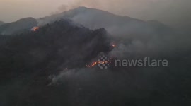 Thai mountain fire nears residential areas as it continues burning