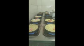 The chef demonstrates her skill in making fried rice cakes on 11 pans
