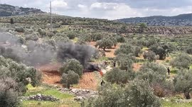 Palestinian protesters burn tyres and hurl stones towards Israeli forces during a demonstration in the village of Beita, south of Nablus in the West Bank, against the establishment of Israeli outposts on their lands