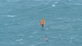 Hydrofoil kiteboarder rides wild seas generated by Storm Mathias in Newquay Bay