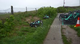 Electric hire bikes scattered by the stormy weather. A towns new hire bikes bowled over by the storm. Newquay Cornwall UK