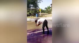 Thrift DIY salon: Woman creates purple puddles washing hair color from leaking water tanker