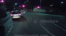 Impatient Car driver can't be bothered waiting for the green light and drives through the red one