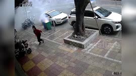 Chinese residents attempting to extinguish fire in roadside bin cause unexpected explosions