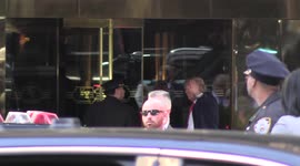 Donald Trump waves to supporters as he arrives at Trump Tower on Monday