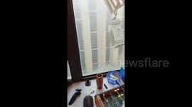 Strong winds rip air conditioning unit off 30-story building in China