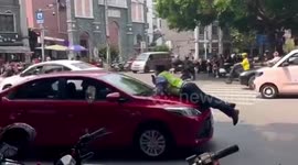 Taxi stops car dragging enforcement officer along road in China