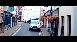Accident: Van Reverses Onto a Biker Knocking Him Off Motorcycle