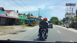 When on a trip driving a car, you meet women driving motorbikes turning on the right turn signal but turning left, what will you do
