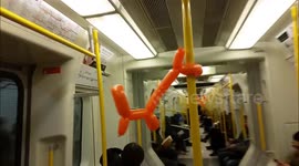 Balloon animals tied to the poles in London Underground train