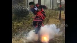 Groom tied to a tree while his friends set off firecrackers underneath him