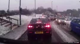 Man slips over on ice while trying to help stuck car