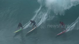 Hawaii surfers ignore warnings to ride monster waves