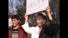 Girl holds up placard in attempt to find boyfriend for Chinese New Year