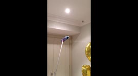 Lady tries to catch huge spider with a broom - while supportive husband films.