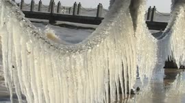 Ice clinging to fences by a lake in China is surprisingly beautiful