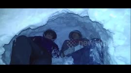 Two kids build igloo in backyard after Storm Jonas