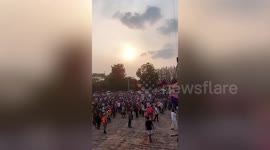 Buddhist monk throws money from crane to celebrate his birthday