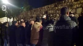 Palestinians perform morning prayers by the Al-Asbat Gate as Israeli police again raided the Al-Aqsa Mosque complex in East Jerusalem early Sunday in Jerusalem