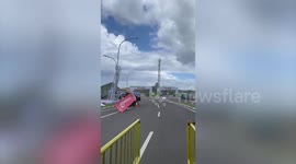 Strong winds blow over banner on roadside in Indonesia