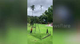 Girl plays on loop-the-loop swing in the Philippines