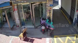 Toddler crashes electric scooter into shop's glass door in China