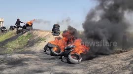 Demonstrators burn tires during a protest over tension in Jerusalem, at the Israel-Gaza border fence, east of Gaza City