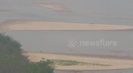 Mekong River has sandbars indicating low water levels at Chiang Saen