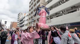 Huge phallic statue paraded through streets as Japan celebrates safe sex festival
