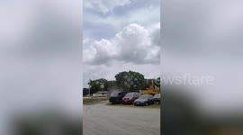 Massive dust devil rips through carpark in front of locals
