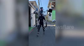 Extraordinary video of Japanese robot fanatic walking down the street in 2.5m-tall human exoskeleton