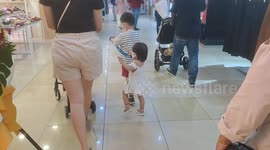Adorable moment of an elder brother led sister using anti lost wrist band