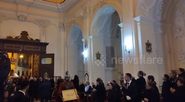 Statue of dead Jesus enters the church welcomed by the faithful, during the Easter procession, which was held in the city of Maddaloni (CE).
