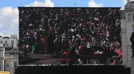At the Passion Of Jesus, open-air play held at Trafalgar Square a member of the audience stumbles as he goes to help Jesus carry the Cross