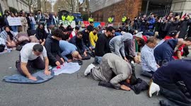 Pro-Palestinian protesters pray in front of Israeli embassy in London after Al-Aqsa mosque police raid
