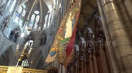Church banners carried to the altar by clergy after Westminster Abbey Easter Day Evensong on 9 April 2023