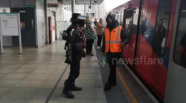 A Storm Trooper from Star Wars gets on a DLR train after visiting the Star Wars Celebration held at The Excel Center