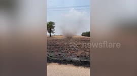 Terrifying dust devil rips through charred field in Thailand