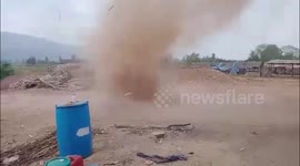 Fast-moving dust devil sends locals fleeing as it rips through field