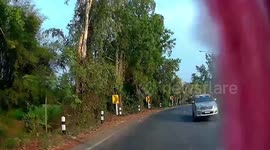 Glass falls from pickup truck on sharp bend in the road